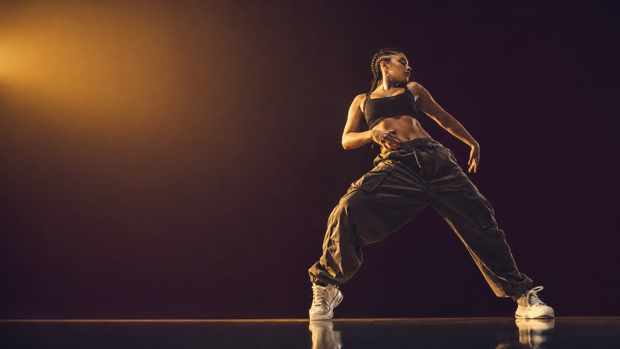 Hip hop dancer in powerful freeze, stage lighting